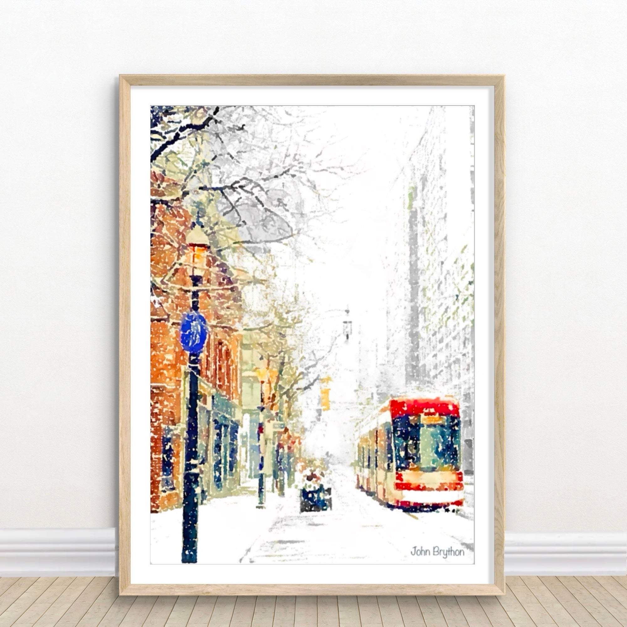 Framed artwork of a snowy street scene in Toronto, Canada. With a red streetcar.
