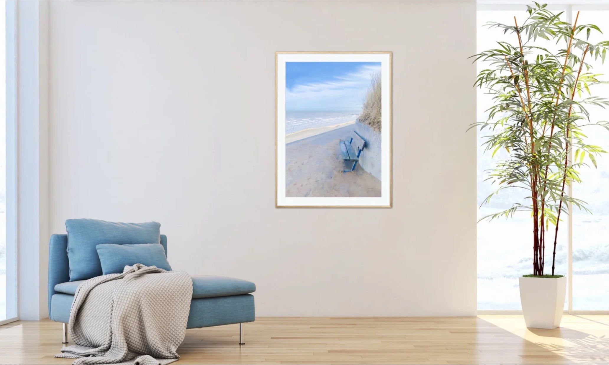 Framed beach print by John Brython on a wall above a blue armchair with a blanket in a bright room. Header for the website of John Brython‘s world of digital art.